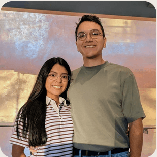 Ignacio standing with a partner indoors.